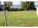 Expansive backyard with mature trees, a chain-link fence, and a clothesline pole at 10327 Old National Rd, Indianapolis, IN 46231
