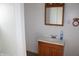 Bathroom featuring sink with cabinet, mirror with lights and neutral paint at 10327 Old National Rd, Indianapolis, IN 46231