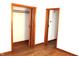 Bedroom features hardwood floors, closet and entry doors, and neutral paint at 10327 Old National Rd, Indianapolis, IN 46231