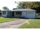 Traditional home featuring a concrete driveway and a tidy, landscaped front yard at 10327 Old National Rd, Indianapolis, IN 46231