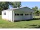 Detached garage with two bays, a side entry door, and ample green space at 10327 Old National Rd, Indianapolis, IN 46231