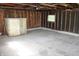 This garage interior shows the concrete flooring and exposed beams, offering potential for a workshop at 10327 Old National Rd, Indianapolis, IN 46231