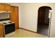 Practical kitchen showcasing a stove, wood cabinets, and connection to the home's interior at 10327 Old National Rd, Indianapolis, IN 46231