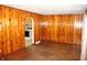 Welcoming living area featuring warm wood walls and flooring, with arched doorways at 10327 Old National Rd, Indianapolis, IN 46231