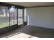 Enclosed patio featuring concrete flooring and view of yard with stairway to yard at 10327 Old National Rd, Indianapolis, IN 46231