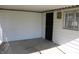 Enclosed patio with concrete floor and access to yard at 10327 Old National Rd, Indianapolis, IN 46231