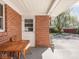 Back porch with outdoor seating and brick exterior at 1035 N Audubon Rd, Indianapolis, IN 46219