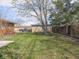 Large backyard with lush green grass and mature trees at 1035 N Audubon Rd, Indianapolis, IN 46219