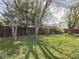 Spacious backyard with wood fence and mature trees at 1035 N Audubon Rd, Indianapolis, IN 46219