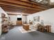 Finished basement with gray carpet, neutral sofa, end tables and accents makes a cozy Gathering room at 1035 N Audubon Rd, Indianapolis, IN 46219