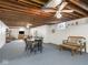 Finished basement with exposed wood ceiling, dining area and bonus space at 1035 N Audubon Rd, Indianapolis, IN 46219