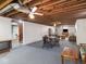 Spacious finished basement featuring exposed ceiling, dining area, and living space at 1035 N Audubon Rd, Indianapolis, IN 46219