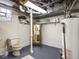 Basement utility area with toilet, mirror, and water heater at 1035 N Audubon Rd, Indianapolis, IN 46219