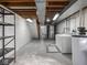Spacious unfinished basement with laundry area and storage at 1035 N Audubon Rd, Indianapolis, IN 46219