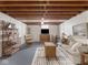 Finished basement with gray carpet, neutral sofa and entertainment center is a versatile living space at 1035 N Audubon Rd, Indianapolis, IN 46219