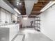 Unfinished basement area featuring laundry, open ceiling, and a treadmill at 1035 N Audubon Rd, Indianapolis, IN 46219