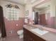 Bathroom with a vanity, mirror, and glass-blocked window at 1035 N Audubon Rd, Indianapolis, IN 46219