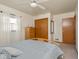 Bright bedroom featuring a ceiling fan, wood closet, and light blue bedding at 1035 N Audubon Rd, Indianapolis, IN 46219