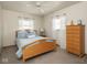 Simple bedroom featuring a bed, dresser, and natural light at 1035 N Audubon Rd, Indianapolis, IN 46219