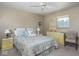 Comfortable bedroom featuring floral bedding, side tables, and a mirror at 1035 N Audubon Rd, Indianapolis, IN 46219
