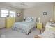 Cozy bedroom with ceiling fan, dresser, and two side tables at 1035 N Audubon Rd, Indianapolis, IN 46219