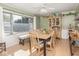 Sunny dining room featuring a large table, ample seating, and a large bright window at 1035 N Audubon Rd, Indianapolis, IN 46219