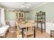 Bright dining room with natural light, featuring a dining table and a charming hutch for storage and display at 1035 N Audubon Rd, Indianapolis, IN 46219