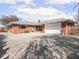 Brick exterior, ranch style home with attached garage and oversized driveway at 1035 N Audubon Rd, Indianapolis, IN 46219