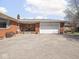 Exterior view of the brick house with a large driveway and garage at 1035 N Audubon Rd, Indianapolis, IN 46219