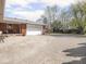 Exterior view of the brick house with a large driveway and garage at 1035 N Audubon Rd, Indianapolis, IN 46219