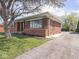 Single-story brick home with a driveway on a sunny day at 1035 N Audubon Rd, Indianapolis, IN 46219