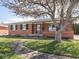 Well-maintained brick home with a sidewalk leading to the front door at 1035 N Audubon Rd, Indianapolis, IN 46219