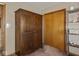 Hallway with wood closet, large armoire, and glass display case at 1035 N Audubon Rd, Indianapolis, IN 46219