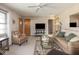 Bright living room featuring neutral walls, plush seating, a ceiling fan, and a large window with natural light at 1035 N Audubon Rd, Indianapolis, IN 46219