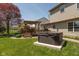 Landscaped backyard featuring a large deck with pergola, hot tub, and a well-maintained green lawn at 1083 Sugar Maple Dr, Greenwood, IN 46143