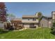 Spacious backyard featuring a deck with pergola, a hot tub, a well-maintained lawn and mature landscaping at 1083 Sugar Maple Dr, Greenwood, IN 46143