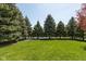 Expansive backyard featuring mature trees, lake views, and a well-maintained lawn at 1083 Sugar Maple Dr, Greenwood, IN 46143
