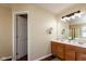 Well lit bathroom featuring double sinks, wood cabinets, large mirror and a door that leads to another bathroom area at 1083 Sugar Maple Dr, Greenwood, IN 46143