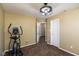 This carpeted bedroom features an elliptical machine, overhead lighting and neutral paint at 1083 Sugar Maple Dr, Greenwood, IN 46143