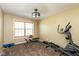 Well lit bedroom featuring an elliptical machine, weight bench, carpet floors and a window overlooking nature at 1083 Sugar Maple Dr, Greenwood, IN 46143