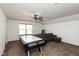 Large carpeted bonus room features an air hockey table, overhead fan and a gray sectional sofa at 1083 Sugar Maple Dr, Greenwood, IN 46143