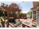 Spacious deck area featuring a dining table, built-in bench, chairs, and pergola with views of the lush backyard at 1083 Sugar Maple Dr, Greenwood, IN 46143