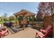 Outdoor deck with dining table, chairs, grill, overhead pergola, and lush tree views in the backyard at 1083 Sugar Maple Dr, Greenwood, IN 46143