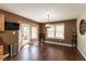 Dining area with modern lighting, wood floors, and large windows offering natural light at 1083 Sugar Maple Dr, Greenwood, IN 46143