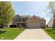 Charming two-story brick home with a well-manicured lawn and inviting curb appeal at 1083 Sugar Maple Dr, Greenwood, IN 46143