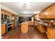 Beautiful kitchen with wood cabinets, an island, stainless steel appliances, and hardwood floors at 1083 Sugar Maple Dr, Greenwood, IN 46143