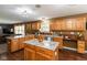 Bright kitchen with wood cabinets, granite countertops, kitchen island and access to the living room at 1083 Sugar Maple Dr, Greenwood, IN 46143