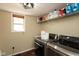 Bright laundry room featuring modern washer and dryer, window, overhead light, and shelf with storage at 1083 Sugar Maple Dr, Greenwood, IN 46143