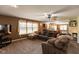 Spacious living room featuring a large sectional sofa, and large windows for natural light at 1083 Sugar Maple Dr, Greenwood, IN 46143