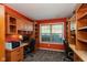 Home office featuring custom built-in shelves and cabinetry, two workspaces, and a large window at 1083 Sugar Maple Dr, Greenwood, IN 46143